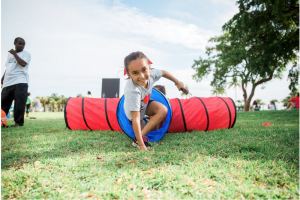 A young walker simulating how blood travels through the pulmonary artery and into the lungs in the Racing Heart obstacle course.